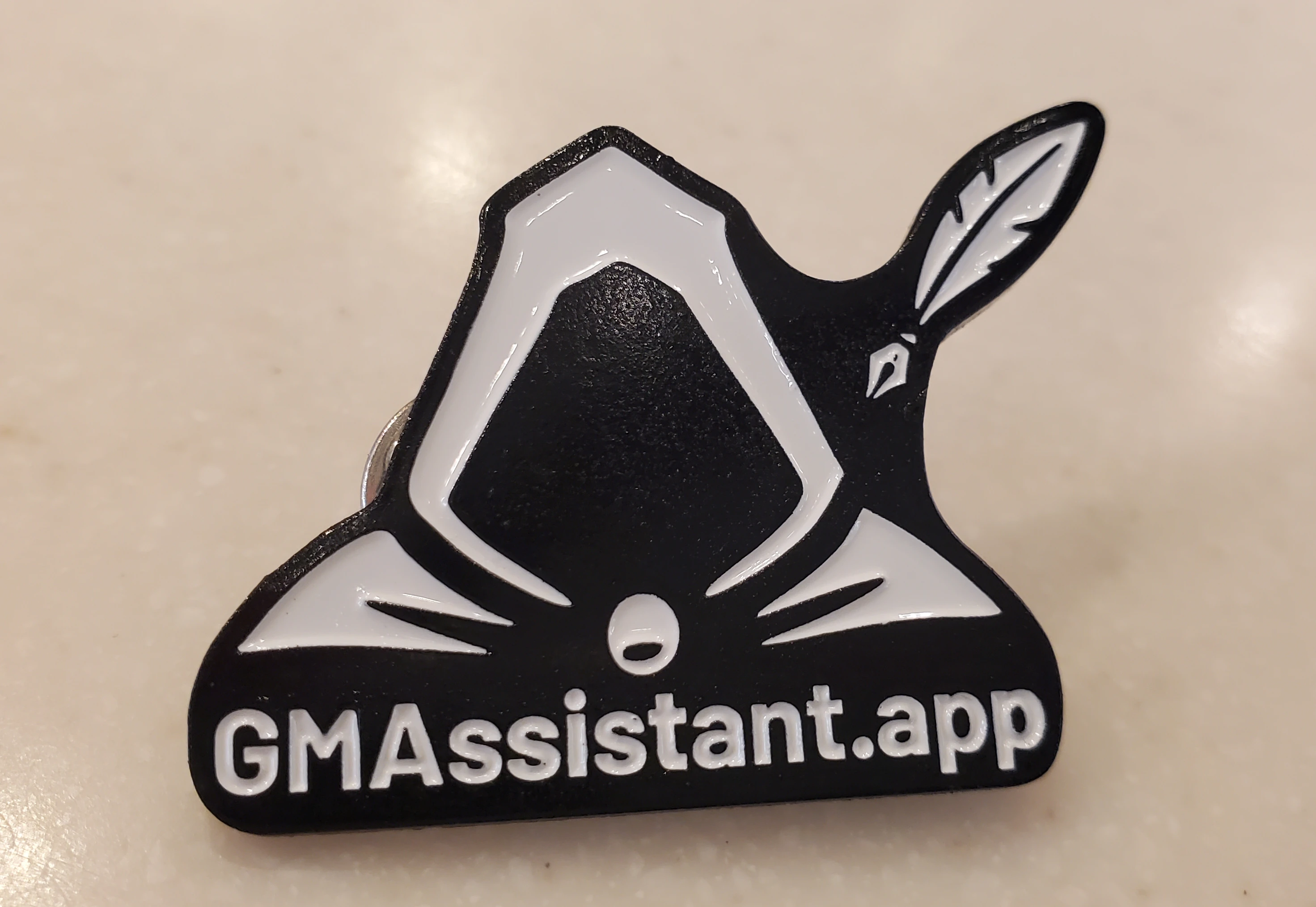 GM Assistant enamel pin featuring the company logo